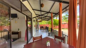 a dining room with a table and chairs on a balcony at La Jungla in Talamanca