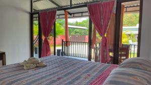a bedroom with a bed with a towel on it at La Jungla in Talamanca