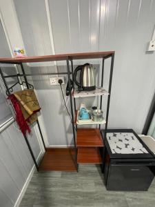 a small room with a shelf with a kettle on it at Casadana Riverview in Kampong Gemuroh