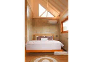 a bed in a small room with a window at Matappa Guest House in Pulau Sarang +69 photos