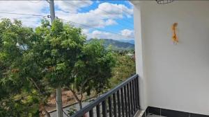 a balcony with a view of trees and mountains at Modern AC Excellent location in Los Jocotes
