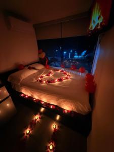 a bedroom with a bed with christmas lights on it at cabañas aldebaran in Ciénega Redonda