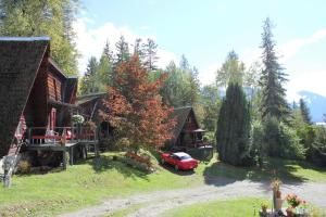 a red car parked in front of a house at Sunny Bluffs Chalets in Kaslo