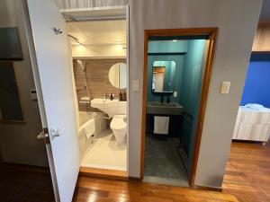 a bathroom with a toilet and a sink at Kokusai Towns Inn in Naha +80 photos