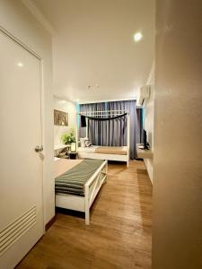 a small room with a bed and a bedroom with a bed sqor at Hotel Tiffany - Laoag in Laoag