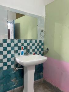 a bathroom with a sink and a mirror at Aura house in Jorhat