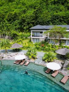 an aerial view of a resort swimming pool with chairs and umbrellas at Thung Nham Resort in Ninh Binh