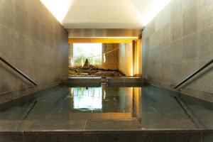 a hallway with a pool of water in a building at Private house 海Kai in Nagato