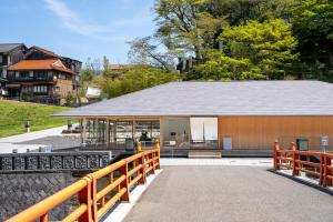 a building with a fence next to a house at Private house 海Kai in Nagato