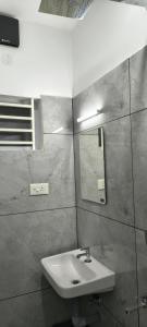 a bathroom with a sink and a mirror at IRIS urban stay in Cochin