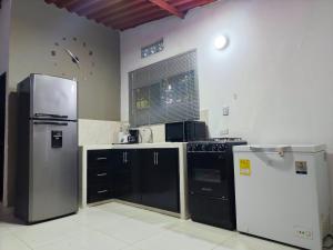 a kitchen with a refrigerator and a stove at Casa Terraza in El Zaino
