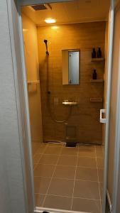 a bathroom with a shower with a mirror at SAKADONEguesthouse in Iijima +14 photos