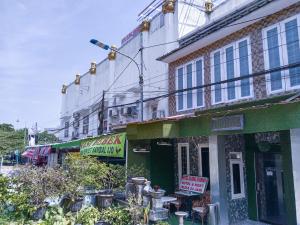a building with a sign in front of it at NamRoom at Jatiwaringin in Jakarta