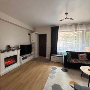 a living room with a couch and a fireplace at Ap DoDe Predeal in Predeal