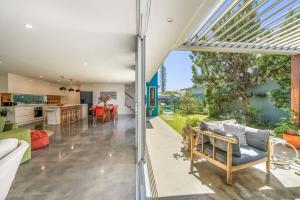 an open living room and kitchen with a view of a house at Beachside Banksia in East Ballina