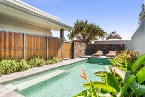 a swimming pool in the backyard of a house at Beachside Banksia in East Ballina