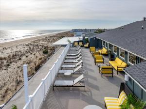 a row of tables and chairs on the beach at Atlantic View Hotel in Dewey Beach