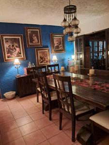 a dining room with a wooden table and chairs at La casa del abuelo in San Felipe de Jesús +14 photos
