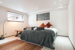 a bedroom with a bed and a table at Hakuba Slopeside Chalet in Otari