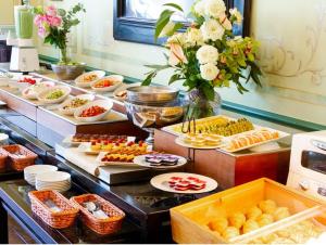 a buffet line with many different types of food at Hotel Monterey Nagasaki in Nagasaki