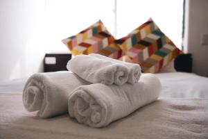 a pile of towels sitting on top of a bed at Hakuba Slopeside Chalet in Otari +75 photos