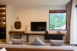 a living room with a tv and a couch at Thung Nham Resort in Ninh Binh