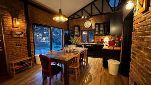 a kitchen with a table with chairs and a clock at Uludag ztrk Mountain House in Kirazlı