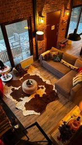 a living room with a couch and a rug at Uludag ztrk Mountain House in Kirazlı