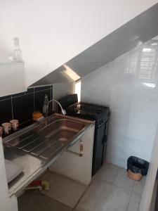 a small kitchen with a sink and a stove at Apartaestudio Central in Chiquinquirá