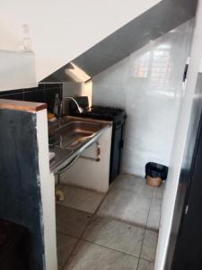 a small kitchen with a sink and a stove at Apartaestudio Central in Chiquinquirá +12 photos