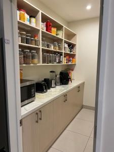 a kitchen with a counter with a microwave at Rana Niwas in Rolleston