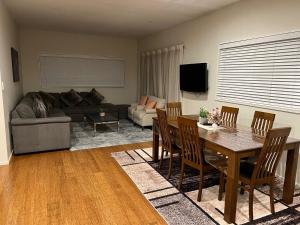 a living room with a table and a couch at Rana Niwas in Rolleston