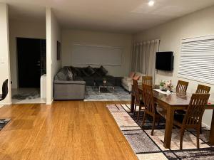 a living room with a table and a couch at Rana Niwas in Rolleston