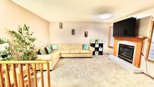 a living room with a couch and a fireplace at Belle-Rive - family friendly Guest House in Edmonton