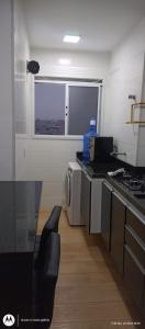 a kitchen with a sink and a stove and a window at Apartamento 88A in São Paulo +6 photos