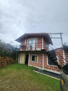 a brick house with a balcony on top of it at villa lyda in San Vicente