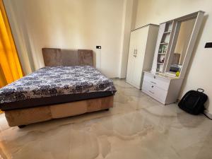a bedroom with a bed and a dresser in it at Colombo - Kelaniya House in Kelaniya