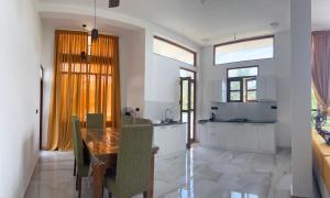 a kitchen and dining room with a wooden table at Colombo - Kelaniya House in Kelaniya