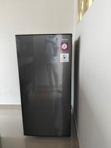 a person taking a picture of a black refrigerator at Japa Amerta Villa in Amed