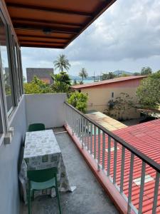 a balcony with a table and a chair on it at Spectacular Sunrise and Mountain Views in Mae Nam