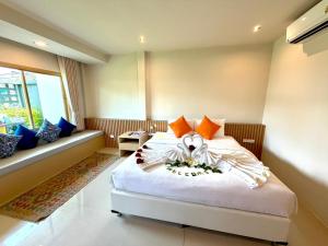 a bedroom with a bed and a couch at Transit Samui Resort in Koh Samui +33 photos