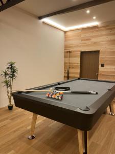 a billiard room with a pool table in a room at KONAYUKI Apartment in Myoko