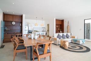 a kitchen and living room with a wooden table and chairs at Tropical Sea View 2Br Private Pool Villa in Plai Laem