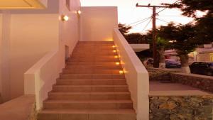 a staircase leading up to a house with lights at Harmonia at Gennadi Court in Gennadi