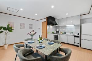 a kitchen and dining room with a table and chairs at Crystal Jade Awaza2-4F in Wada