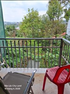 a balcony with a table and a chair on a porch at Lương Y Trần Thúy Liên in Bảo Lộc