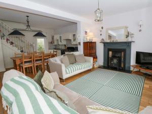 a living room with a couch and a fireplace at Rose Cottage in Cardigan