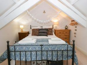 a bedroom with a bed in a attic at Rose Cottage in Cardigan