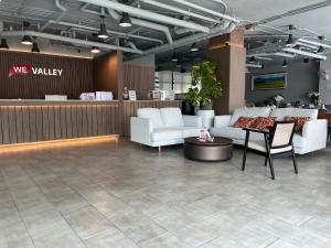 a lobby with couches and a table in a store at WE Valley Hotel in Chiang Mai