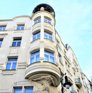 a tall white building with a round window at Old Town Square Superior Apartments - Valentin in Prague